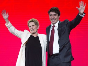 Prime Minister Justin Trudeau and Ontario Premier Kathleen Wynne wave to the crowd at the federal Liberal national convention in Halifax on Friday, April 20, 2018. (THE CANADIAN PRESS/Andrew Vaughan)