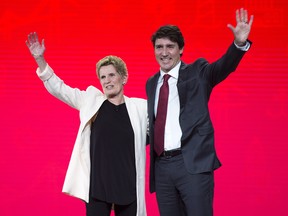 Prime Minister Justin Trudeau and Ontario Premier Kathleen Wynne wave to the crowd at the federal Liberal national convention in Halifax on Friday, April 20, 2018. (THE CANADIAN PRESS/Andrew Vaughan)