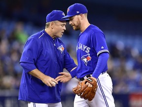 Toronto Blue Jays relief pitcher Danny Barnes, right, is removed from the game by manager John Gibbons during seventh inning interleague baseball action against the Atlanta Braves in Toronto, Tuesday, May 16, 2017. THE CANADIAN PRESS/Frank Gunn