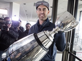 Toronto Argonauts quarterback Ricky Ray holds the Grey Cup as speaks to members of the media as the teams returns to Toronto on Monday, November 27 2017. After a celebration that lasted into the wee hours, a tired group of Toronto Argonauts arrived home Monday morning with the Grey Cup in tow. THE CANADIAN PRESS/Chris Young ORG XMIT: CHY105 ORG XMIT: POS1711271117301827