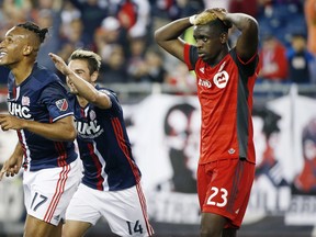 New England Revolution's Juan Agudelo (left) celebrates his goal with teammate Diego Fagundez in front of Toronto FC's Chris Mavinga during a game last year. (AP PHOTO)