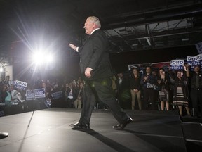 Ontario Progressive Conservative leader Doug Ford is greeted by enthusiastic supporters at a rally in Etobicoke on Tuesday night. (THE CANADIAN PRESS)
