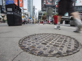 People walk close to the location where Israel Edwards was gunned down. (ERNEST DOROSZUK, Toronto Sun)
