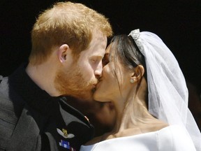 Prince Harry and Meghan Markle kiss on the steps of St George's Chapel in Windsor Castle after their wedding. (Ben Birchhall/pool photo via AP)