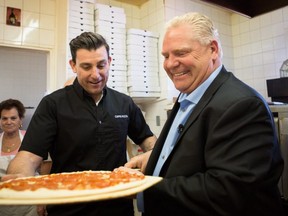 Ontario PC leader Doug Ford helps make pizza during a campaign stop at Capri Pizza  in Cambridge on  May 17, 2018. THE CANADIAN PRESS