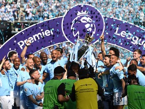 Manchester City celebrates with the Premier League trophy. (GETTY IMAGES)