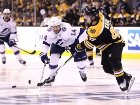 Chris Kunitz #14 of the Tampa Bay Lightning and Torey Krug #47 of the Boston Bruins compete for control of the puck during the second period of Game Three of the Eastern Conference Second Round during the 2018 NHL Stanley Cup Playoffs at TD Garden on May 2, 2018 in Boston, Massachusetts.