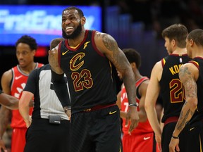 LeBron James of the Cleveland Cavaliers reacts after taking a hard foul during Game 3 against the Toronto Raptors at Quicken Loans Arena on May 5, 2018