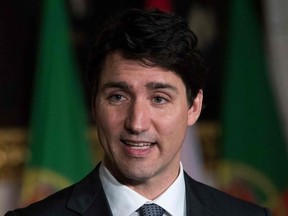 (FILES) In this file photo taken on May 3, 2018 Canadian Prime Minister Justin Trudeau speaks during a joint media availability with Portuguese Prime Minister António Costa(not pictured) on Parliament Hill in Ottawa, Ontario. Prime Minister Justin Trudeau said May 9, 2018 that he will apologize for Canada's refusal to admit Jewish asylum seekers fleeing Nazi Germany just months before the start of World War II. On May 13, 1939 the ocean liner MS St. Louis departed Germany with 907 German Jews aboard and crossed the Atlantic Ocean "desperate for safety and refuge from persecution," according to a statement from Trudeau's office.