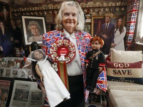 Royal fan Margaret Tyler poses with her dolls called Harry and Meghan and her collection of royal memorabilia that decorates her Bed & Breakfast establishment in London, Friday, May 11, 2018. The world's eyes are on the upcoming royal wedding of Britain's Prince Harry and Meghan Markle.