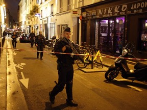 A police officer cordons off the area after a knife attack in central Paris, Saturday May 12, 2018. The Paris police said the attacker was subdued by officers during the stabbing attack in the 2nd arrondissement or district of the French capital Saturday.