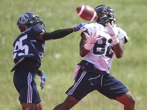 Toronto Argos receiver Malcom Williams (82) makes an over the shoulder TD catch against Ronnie Yell (25) during practice in Toronto on Wednesday May 30, 2018. (Jack Boland/Toronto Sun)
