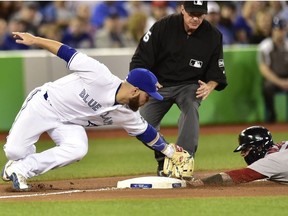 Toronto Blue Jays third baseman Russell Martin (55) tags out Boston Red Sox catcher Christian Vazquez (7) on a steal attempt during seventh inning American League baseball action in Toronto on Saturday, May 12, 2018.