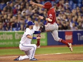 Los Angeles Angels' Zack Cozart is tagged out at third by Toronto Blue Jays third baseman Josh Donaldson (20) during sixth inning American League baseball action in Toronto on Wednesday, May 23, 2018. (THE CANADIAN PRESS/Frank Gunn)
