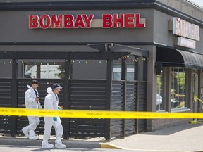 Investigators working out of Peel Regional Police Forensics Identification Services van, investigate a bombing from the previous night at the Bombay Bhel restaurant in Mississauga, Ont. on Friday May 25, 2018. Ernest Doroszuk/Toronto Sun