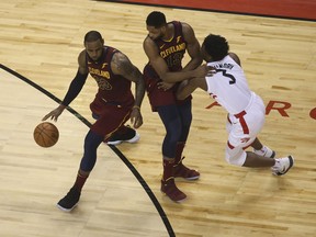 Cleveland Cavaliers' Tristan Thompson sets a pick against Toronto Raptors' OG Anunobyto let Lebrpn James through during Game 2 at the Air Canada Centre on May 3, 2018