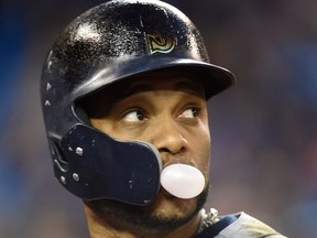 Seattle Mariners' Robinson Cano blows a bubble as he looks towards the field after he lined out during fifth inning American League MLB baseball action against the Toronto Blue Jays in Toronto on May 9, 2018