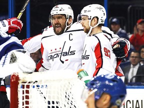 Alex Ovechkin #8 of the Washington Capitals celebrates with teammate Evgeny Kuznetsov #92 after scoring a goal against Andrei Vasilevskiy #88 of the Tampa Bay Lightning.  (Photo by Bruce Bennett/Getty Images)