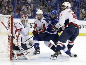 Tampa Bay Lightning center Cedric Paquette (13) tries to get past Washington Capitals left wing Alex Ovechkin (8), and defenseman Matt Niskanen (2) for a rebound on goaltender Braden Holtby during the second period of Game 5 of the NHL Eastern Conference finals hockey playoff series Saturday, May 19, 2018, in Tampa, Fla. (AP Photo/Chris O'Meara) ORG XMIT: TPA114