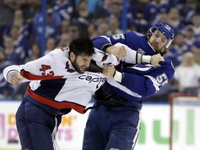 Lightning defenceman Braydon Coburn (right) and Capitals winger Tom Wilson go toe to toe during the first period of Game 7 last night. (Chris O’Meara/The Associated Press)