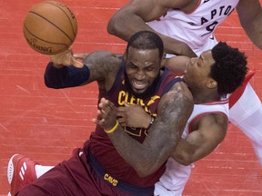 Toronto Raptors' Kyle Lowry fouls Cleveland Cavaliers' LeBron James late in first half NBA playoff action at the Air Canada Centre on May 3, 2018