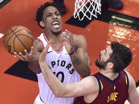 Raptors guard DeMar DeRozan (left) drives to the basket aagainst Cleveland Cavaliers centre Kevin Love during Game 1 of their series on Tuesday night at the Air Canada Centre. (Frank Gunn/The Canadian Press)