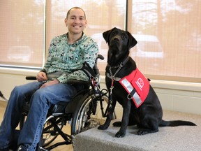 Jeff Poirier and his black lab guide dog Rhyme