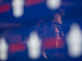 Kyle Dubas is reflected in a screen as he scrums with reporters at a press conference after being introduced as the new general manager of the Toronto Maple Leafs in Toronto on May 11, 2018