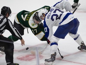 Toronto Marlies forward Peter Holland takes a draw against Texas Stars forward Chris Mueller during the AHL playoffs at Ricoh Coliseum on May 29, 2014