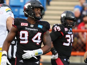 Calgary Stampeders defensive lineman Frank Beltre smiles after stopping an Edmonton Eskimos play in Calgary on Monday September 5, 2016. (Gavin Young/Postmedia)