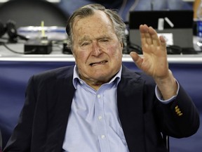Former U.S. President George H. W. Bush waves as he arrives at NRG Stadium before the NCAA Final Four tournament college basketball semifinal game between Villanova and Oklahoma in Houston on April 2, 2016. (AP Photo/David J. Phillip)