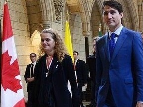 Canada's incoming Governor General Julie Payette walks with Prime Minister Justin Trudeau as she arrives on Parliament Hill in Ottawa on Monday, Oct. 2, 2017, for her installation ceremony.