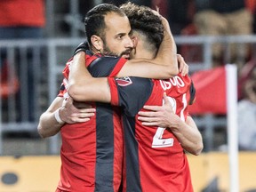 Toronto FC midfielder Victor Vazquez (left) celebrates with Jonathan Osorio after scoring his team's opening goal against Philadelphia Union during first half MLS action in Toronto on May 4, 2018