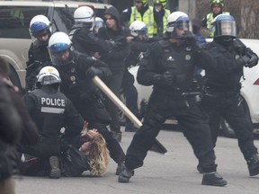 Riot police engage with protesters during a May Day demonstration held by the Convergence des lattes anti-capitalistes in Montreal.
