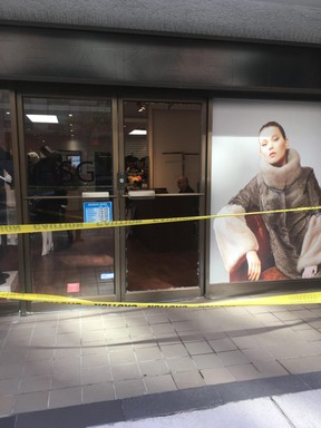 A window is shattered at Herman Sellers Gough Furs, 1255 Bay St. in Yorkville, and police tape remains after the fatal shooting of a man on the street late Monday, May 28, 2018. (Kevin Connor/Toronto Sun)