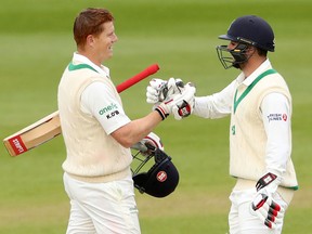 Ireland's Tyrone Kane, right, congratulates teammate Kevin O'Brien on his Test Century on day four of the International Test Match against Pakistan at The Village in Dublin, Ireland on May 14, 2018