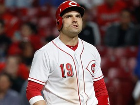 Cincinnati Reds' Joey Votto reacts alongside Milwaukee Brewers catcher Manny Pina after striking out swinging against relief pitcher Josh Hader in the seventh inning of a game on April 30, 2018