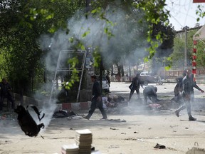 Victims in double explosions lie on the ground in Kabul, Afghanistan, Monday, April 30, 2018. (AP Photo/Massoud Hossaini)