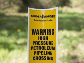 A sign where buried pipelines are located is seen in Burnaby B.C., just outside the Kinder Morgan location Thursday, April 26, 2018.