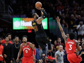Cleveland Cavaliers' LeBron James hits the game-winning shot as Toronto Raptors' OG Anunoby and CJ Miles watch during the second half of Game 3 of an NBA basketball second-round playoff series, Saturday, May 5, 2018, in Cleveland.  (AP Photo/Tony Dejak)