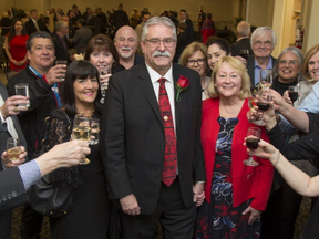 Dave Levac (centre) and his wife Rosemarie are surrounded by well-wishers raising a toast to the retiring Brant MPP and Speaker of the Ontario Legislature, during a party on Friday April 27, 2018 at the Best Western Brantford Hotel and Conference Centre in Brantford, Ontario.