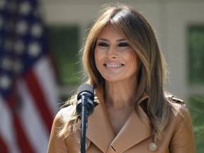 In this May 7, 2018 photo, First lady Melania Trump speaks on her initiatives during an event in the Rose Garden of the White House in Washington. The White House says Melania Trump is hospitalized after undergoing a procedure to treat a benign kidney condition.