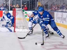 Marlies’ Trevor Moore carries the puck as Syracuse Crunch defenceman Erik Cernak gives chase and Crunch goalie Eddie Pasquale looks on during Game 1 of their second-round series last night at the Ricoh Coliseum. (Christian Bonin/Photo)