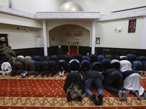 Members of the Salaheddin Islamic Centre mosque pray in Scarborough on Monday January 30, 2017. (Jack Boland/Toronto Sun)