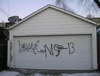 Gang grafitti tag is seen on a garage door in the GTA as Toronto Police and Halton Regional Police executed 22 search warrants, made 17 arrests and laid 63 charges following a five-month investigation into alleged members of the notoriously violent Mara Salvatrucha, aka MS-13 gang.