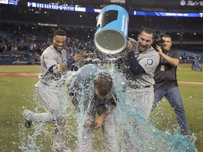 Seattle Mariners pitcher James Paxton, from Ladner, B.C., is hit with Gatorade by teammates Robinson Cano and Mike Zunino after he pitched a no-hitter against the Toronto Blue Jays in Toronto on Tuesday May 8, 2018. (THE CANADIAN PRESS/Fred Thornhill)