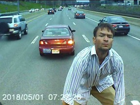 A man jumps on the hood of a school bus on the Massachusetts Turnpike on May 1, 2018.