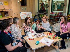 Ontario Premier Kathleen Wynne visits Jessica Hill and her baby Audrey Marie Gadoury at the Sick Kids Hospital in Toronto on Thursday, May 10, 2018.