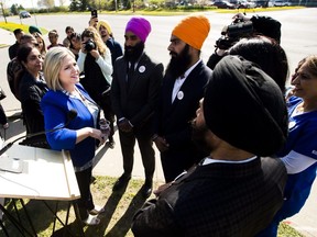 NDP Leader Andrea Horwath, left, talks with supporters after making a campaign announcement on health care in Brampton on Monday, May 14, 2018. THE CANADIAN PRESS/Nathan Denette