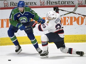 Swift Current Broncos defenceman Colby Sissons battles with Regina Pats centre Sam Steel during the first round of the WHL playoffs.